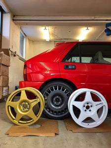 Lancia Delta HF integrale Rosso Monza with OZ style Aero wheels sitting behind two Speedline Corse 5 spoke Race/Rallye wheels
